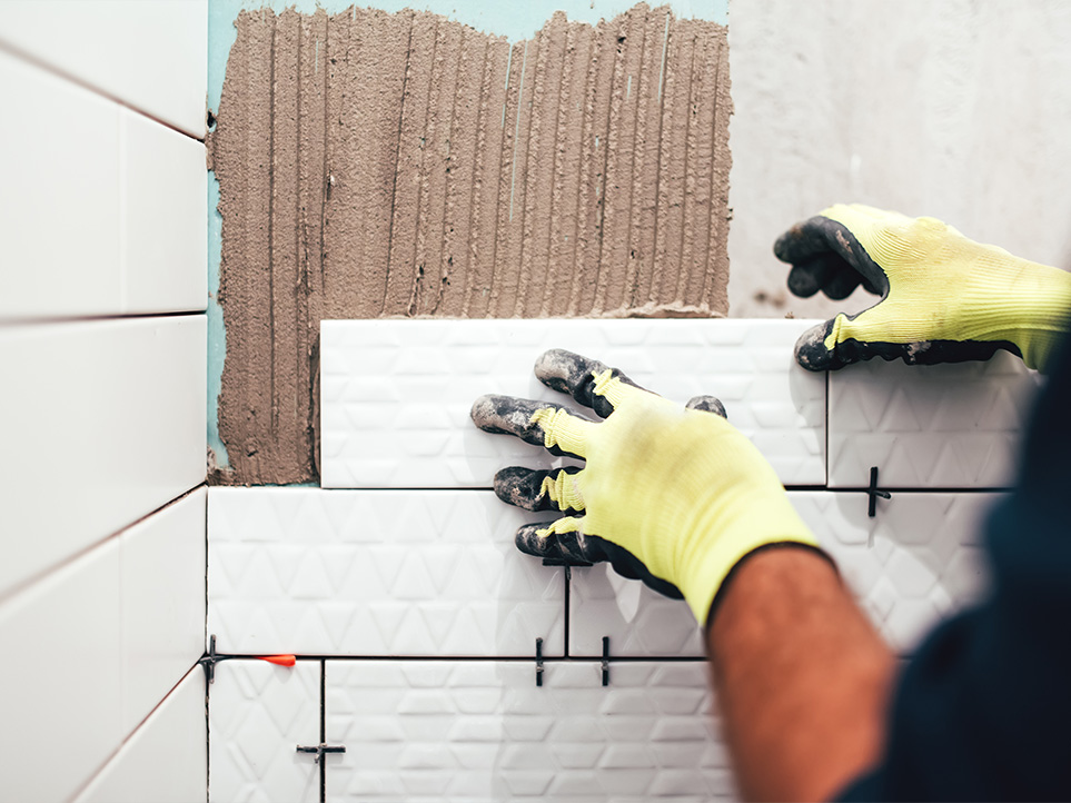 Installing tiles with primer applied to ensure a strong bond before sealing